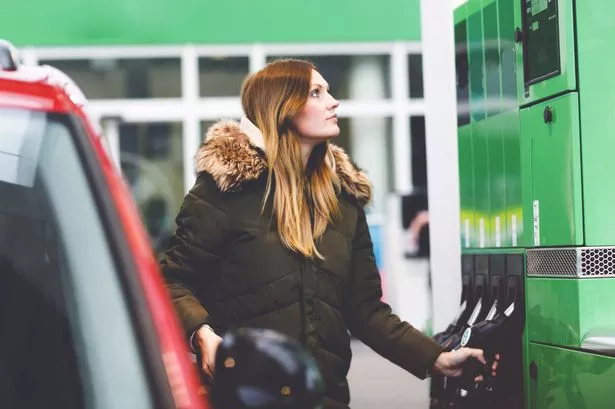 Young Woman at Self-Service Gas Station, Hold Fuel Nozzle and Refuel The Car with Petrol, Diesel, Gas. 