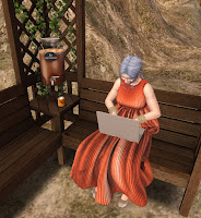 Photo Taken in the 3D virtual World, Second Life of Sheila Sitting in a Bower on a Mountain Working at A Computer With A Cup of Hot Chocolate
