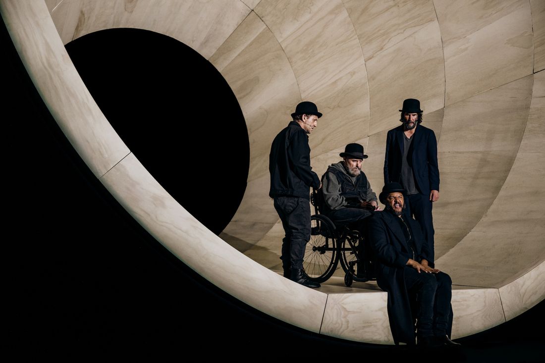 (L to r): Alex Winter as 'Vladimir,' Michael Patrick Thornton as 'Lucky' (in Wheel Chair), Brandon J. Dirden as 'Pozzo' (Seated on Stage), and Keanu Reeves as 'Estragon.'