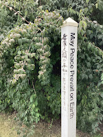 Photo by Sheila Webber of a Peace Post at Charlton House in August 2024 The Post May Peace Prevail on Earth