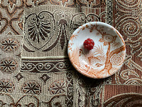 A Photo of a mulberry on a small china plate