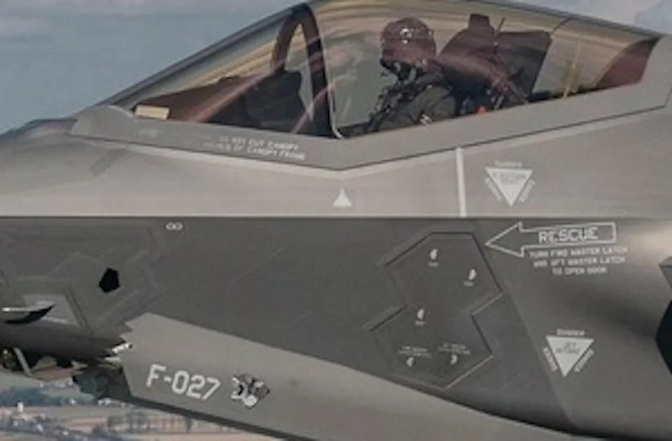 The Side of a Gray Aircraft with a White Drone-Saped Mark