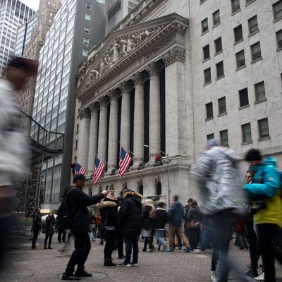 Pedestrians pass in front of the New York Stock Exchange (NYSE) in New York, US, on Tuesday, Dec. 31, 2019. US stocks fell in thin end-of-year trading, as rising tensions in the Middle East drove some profit taking after one of the strongest years for equities in the past decade. Photographer: Michael Nagle/Bloomberg via Getty Images