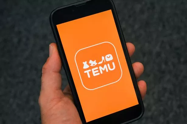 (FILES) This photograph shows the logo of Chinese e-commerce company Temu displayed on a mobile phone, in Brussels, on November 4, 2024. The European Union accused Chinese-founded online shopping giant Temu on July 28, 2025 of breaking the bloc's digital rules by not "properly" assessing the risks of illegal products. EU regulators believe Temu is not doing enough to protect European consumers from dangerous products and that it may not be acting sufficiently to mitigate risks to users. (Photo by Nicolas TUCAT / AFP) (Photo by NICOLAS TUCAT / AFP via Getty Images)
