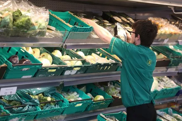 Morrisons Worker Replenishing shelves
