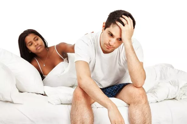 COUPLE IN BED LOOING STRESSED