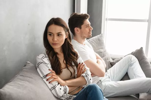 A woman looking upset with a man