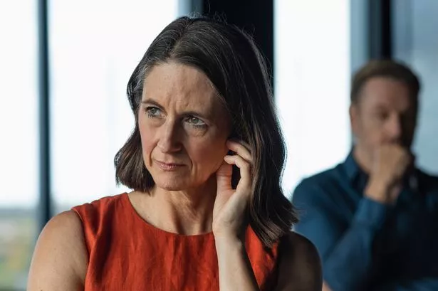A Woman Looking UPSET WITH A MAN STANDING BIBIND HER