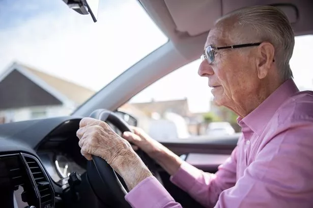 World Senior Male Driver Looking Through Car Windscreen