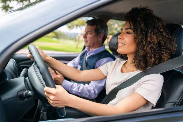 Young Woman Sat in Car Taking Driving Test (Stock Photo)