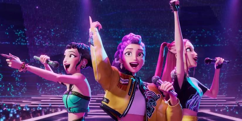 HUNTR/X smiling as they perform on stage in KPop Demon Hunters