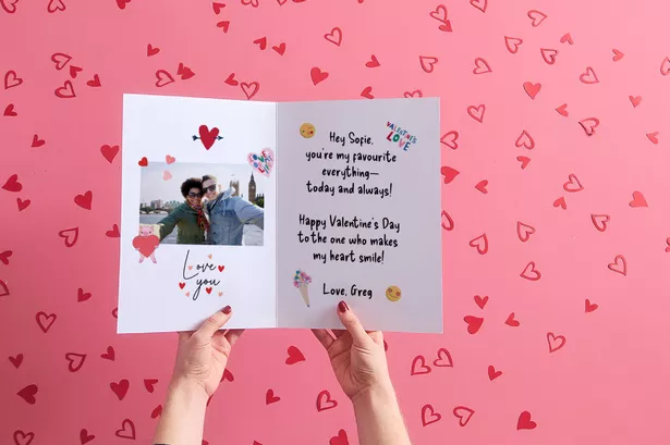 A Pair of Hands Holding A Card