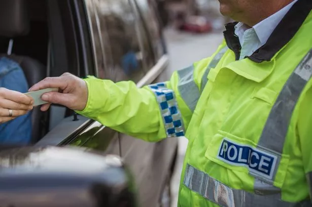 Man and Woman, Police officer Making A Traffic Stop on the Street.