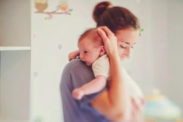 Mother holding her baby daughter