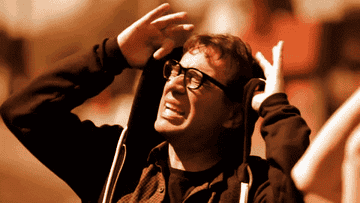 fred armisen wearing hood and yelling at sun