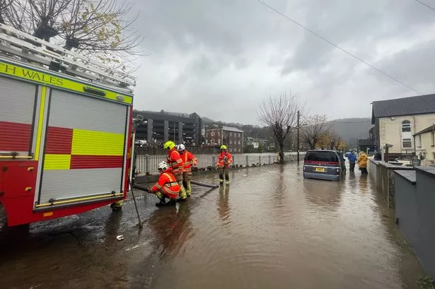 Firefighters Pumping Water From A Street by the River Taff, in Pontypridd, Wales