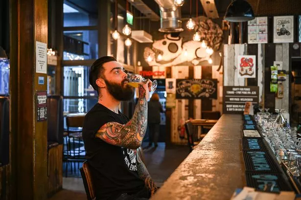   A man drinks in the brewdog pub in the cowgate