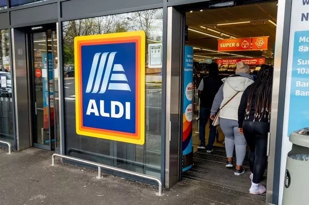 The entrance and exit of a branch of Aldi grocery supermarket