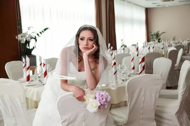 A BRIDE LOOING UPSET ON HER WEDDING DAY
