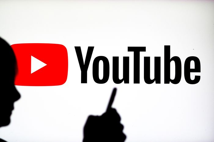 In this photo illustration, a YouTube logo seen on display