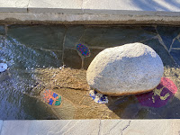 Photo by Sheila Webber of a water feature in a park in Vancouver in May 2024 with a stone and mosaic at the bottom of teh water channel