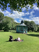 Photo by Sheila Webber: Bandstand in Sheffield, Original Home of Information Research. A Family Sit on the Grass in the Partk on a Sunny Day With the Bandstand in the Middle Distance