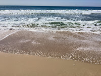 Photo by Sheila Webber of Bournemouth Beach With The Sea Sparkling and Waves Lapping the Beach in June 2024