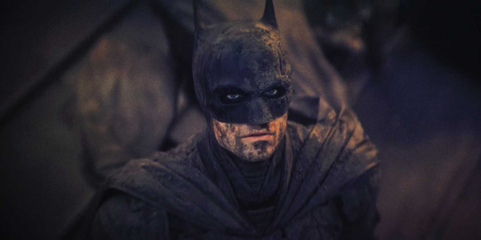 Robert Pattinson's Batman looking up while dirty in The Batman