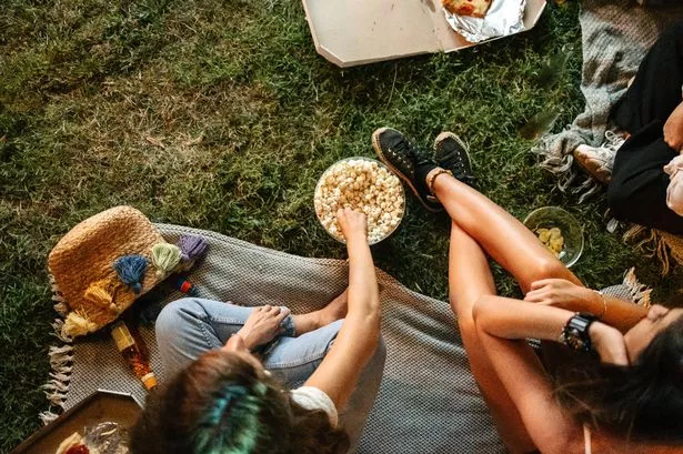 High angle view of female friends watching a movie in an open air cinema