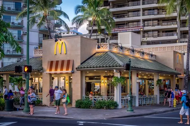 Waikiki, HI, USA - April 27, 2014: Busy McDonald's restaurant on Kalakaua Avenue in Waikiki. McDonald's is a global brand and dominant force in fast food retail.