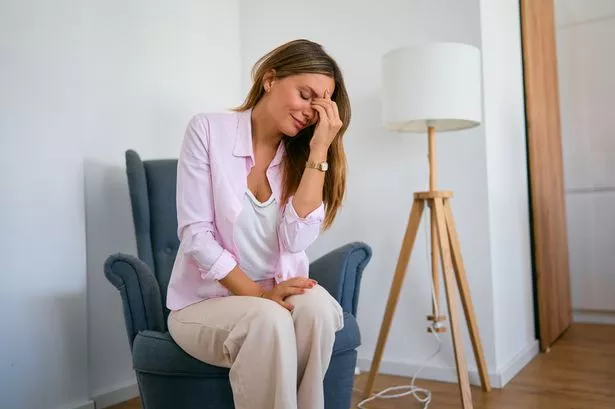 Stressed businesswoman experiencing a severe headache