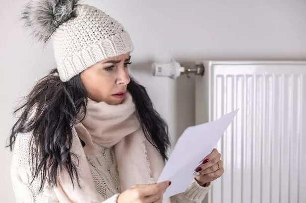   woman is shocked from the rising energy costs and the bill she received for heat and electricity for her household.