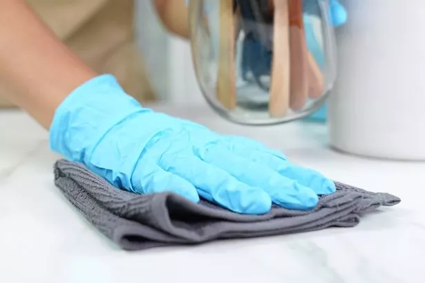 Homemaker wear washing glove scrubbing and cleaning Kitchen counter, Housework